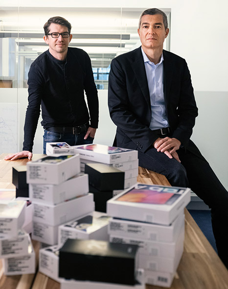 men standing next to stacks of boxes